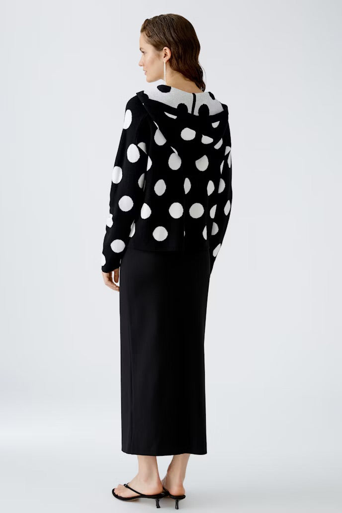 Black knitted hoodie with large polka dots in cream