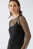 Glitter black mesh top over opaque strappy top in black