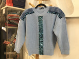 Cropped blue sweater with sequin and fur trims