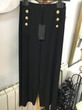 Black palazzo trousers with gold buttons and slit detail