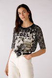 Black and taupe patterned top with rebel logo